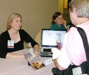 RuthAnn Hogue sells and signs books during NFPW Annual Conference in Seattle.